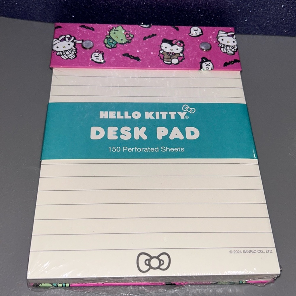 Hello Kitty in Halloween Costumes Desk Pad with perforated sheets